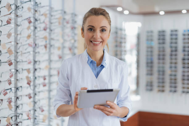 istock Positive female ophthalmologist standing at the optical store 1135962933