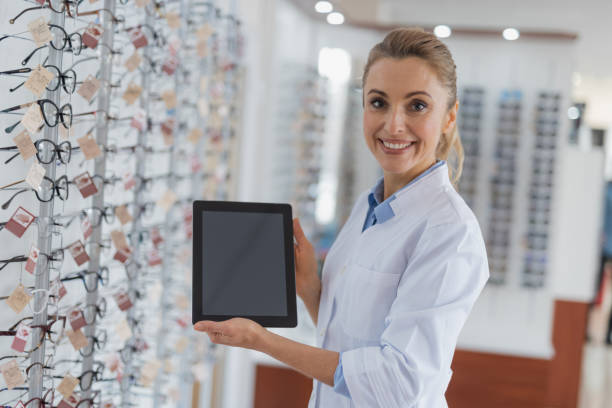 istock Joyful professional optician working at the optics 1135962934
