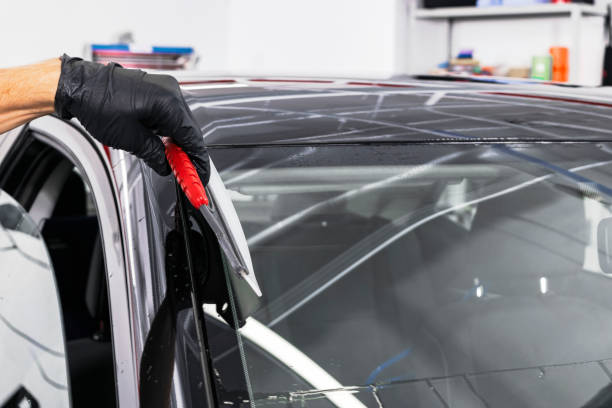 istock A man cleaning car with plastic sponge. Car detailing or valeting concept. Selective focus. Car detailing. Cleaning with sponge and cloth. Worker cleaning. Car wash concept solution to clean 1135963310