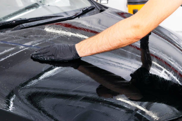 istock A man cleaning car with microfiber cloth. Car detailing or valeting concept. Selective focus. Car detailing. Cleaning with sponge. Worker cleaning. Car wash concept solution to clean 1135963650