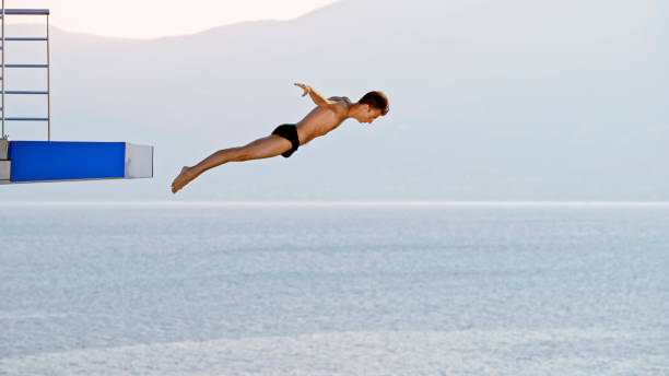 istock Young man diving into swimming pool 1135963806