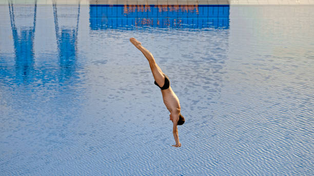istock Young man diving into swimming pool 1135964329