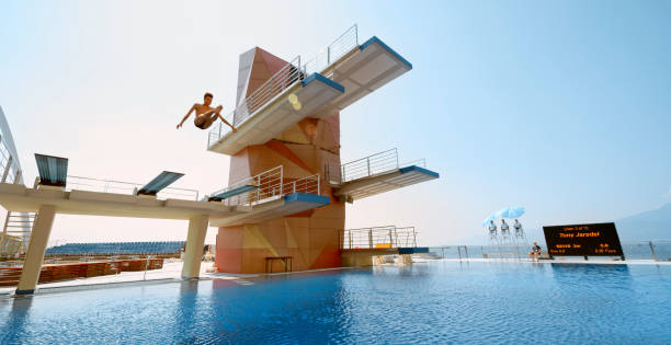 istock Male diver diving into swimming pool 1135964363