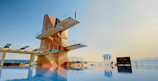 istock Male diver standing on diving board before jump 1135964394