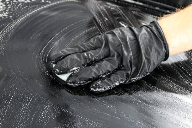 istock A man cleaning car with microfiber cloth. Car detailing or valeting concept. Selective focus. Car detailing. Cleaning with sponge. Worker cleaning. Car wash concept solution to clean 1135964463