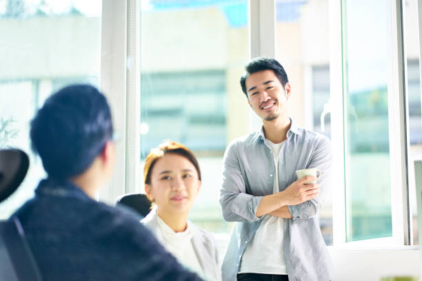 istock young asian coworkers chatting in office 1135964511