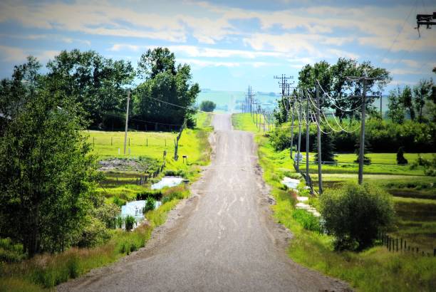 istock Old Country Road that Leads Upward Toward the Clouds and Beyond 1135965256