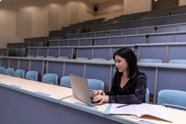 istock Woman working on laptop in a classroom 1135965807