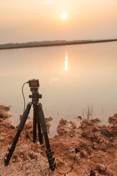 istock Take pictures sunset at the river with Action camera on tripod 1135966503