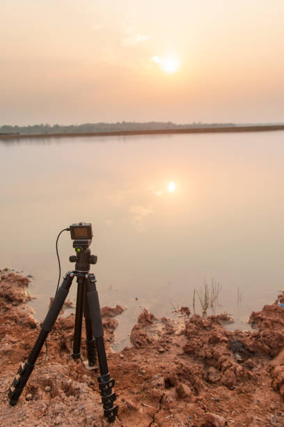 istock Take pictures sunset at the river with Action camera on tripod 1135966976
