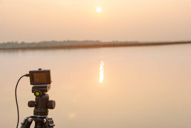 istock Take pictures sunset at the river with Action camera on tripod 1135967071