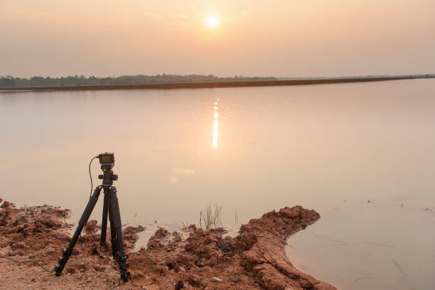 istock Take pictures sunset at the river with Action camera on tripod 1135967106