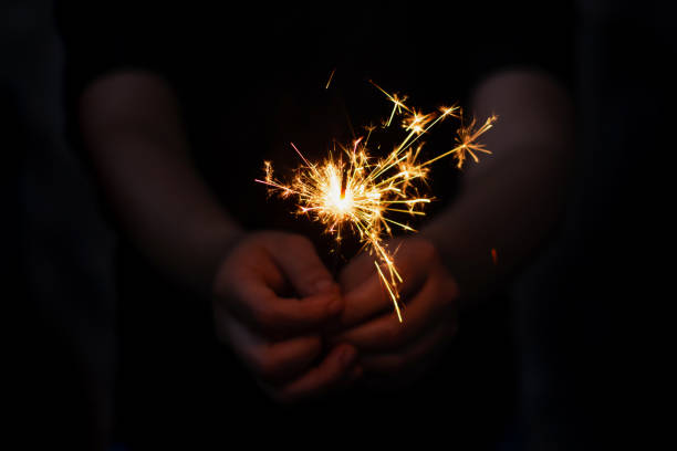 istock Woman hand holding a burning sparkler 1135967541