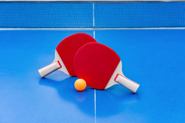 istock pingpong rackets and ball and net on a blue pingpong table 1135967553