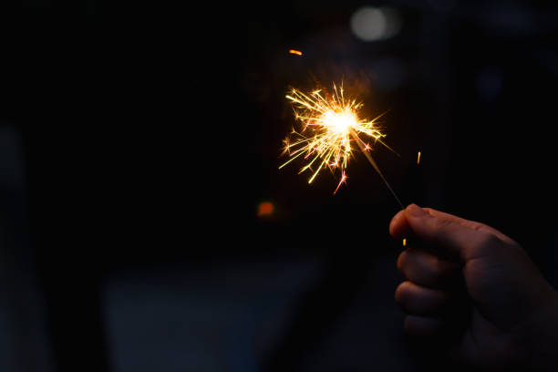istock Woman hand holding a burning sparkler 1135969164