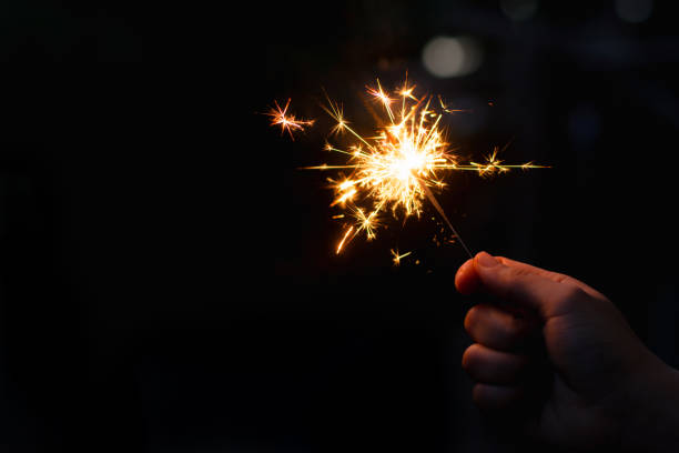 istock Woman hand holding a burning sparkler 1135969330