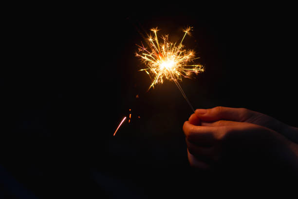 istock Woman hand holding a burning sparkler 1135969389