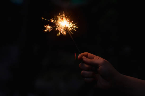 istock Woman hand holding a burning sparkler 1135969456