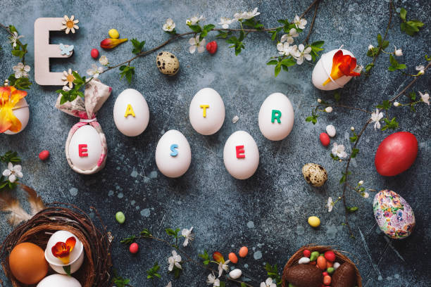 istock Easter holiday concept with different  quail and chicken eggs on a rustic surface.  Easter word written on  eggs 1135969505