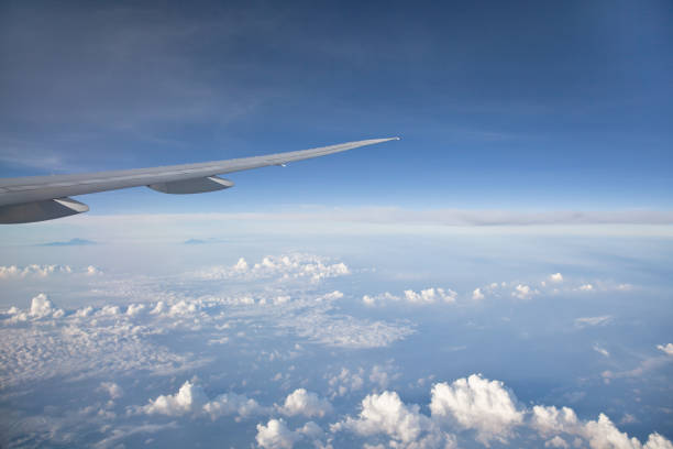 istock Blue sky with white clouds and the wing of the plane. 1135969508