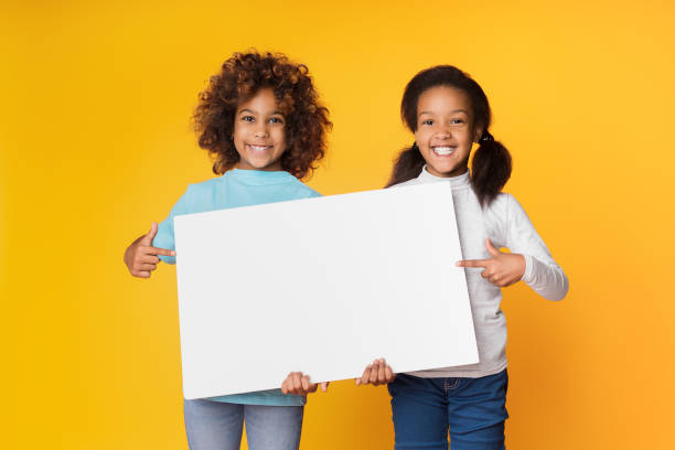 Child girls holding empty banner for your text