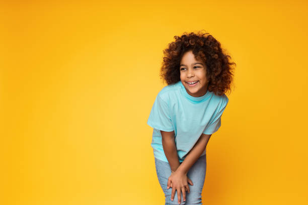 istock Cute african-american girl posing over studio background 1135969535