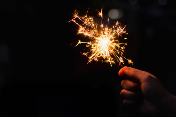 istock Woman hand holding a burning sparkler 1135969574