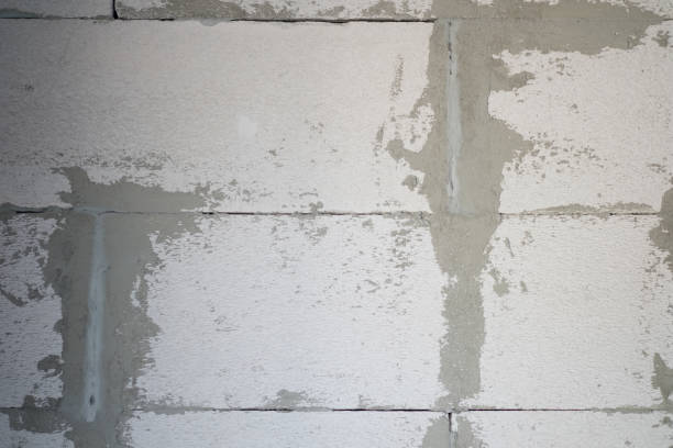 istock Construction renovation exterior walls and installing stone with mortar 1135970008