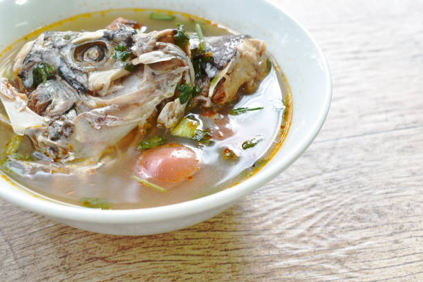 istock spicy boiled Tilapia head fish in tom yum soup 1135970111