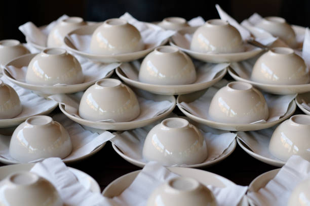 istock Set of empty white ceramic cup and saucers in rows for serving in restaurant 1135970112
