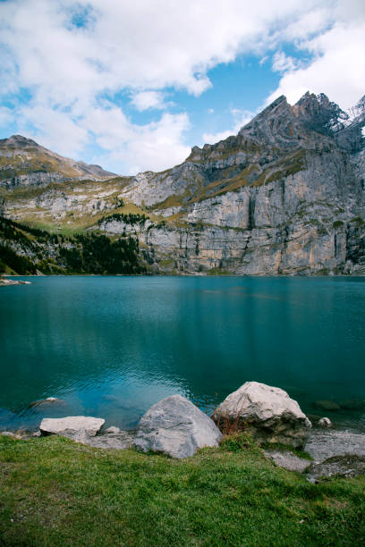 View of Oeschinen Lake in the Swiss alps with beautiful turquoise water. Nature and travel concepts. View of Oeschinen Lake in the Swiss alps with beautiful turquoise water. Nature and travel concepts. lake oeschinensee stock pictures, royalty-free photos & images