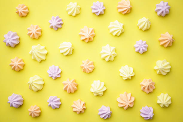 istock colorful meringue cookies on yellow background 1135971029