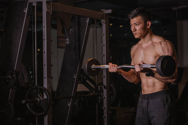 istock Fit Chinese guy training alone in gym 1135971072