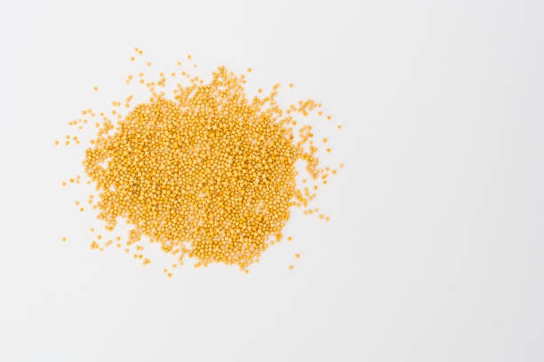 istock Yellow mustard seeds on white 1135972510
