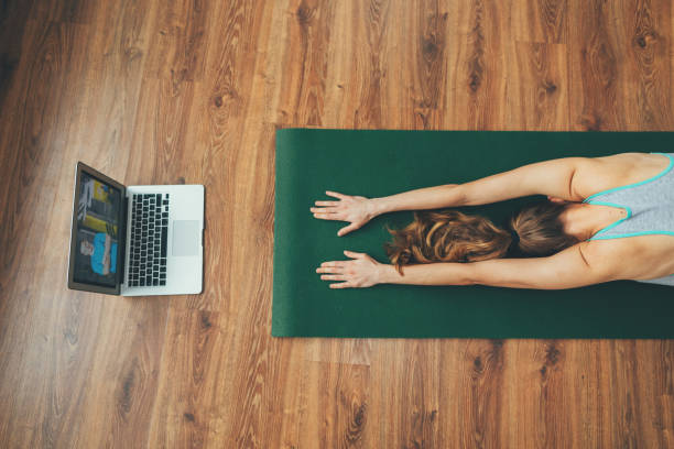 istock Young balanced lady sitting in child's yoga pose 1135972899