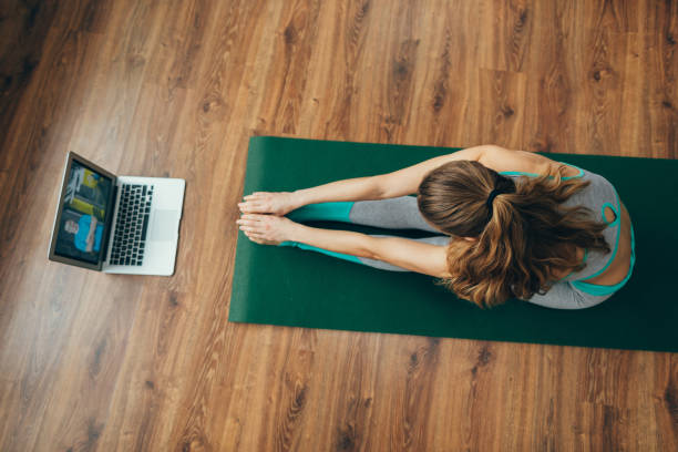 istock Young lady sitting in paschimottanasana yoga pose 1135972906