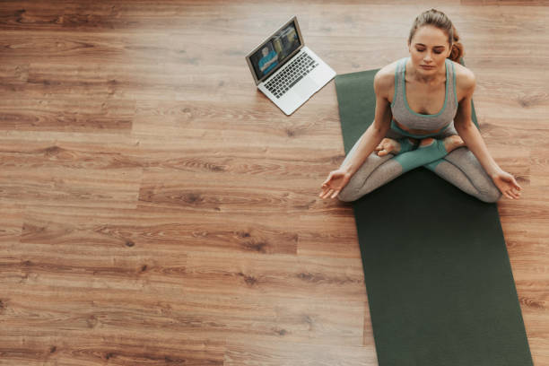 istock Young woman practicing padmasana yoga pose alone 1135972927