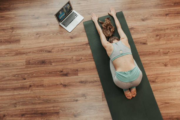 istock Young lady doing child's yoga pose at home 1135972929