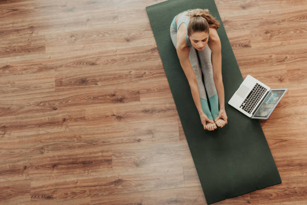 istock Top view woman in paschimottanasana yoga pose 1135972933
