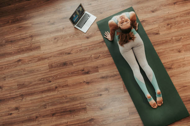 istock Young lady doing cobra yoga pose at home 1135972934