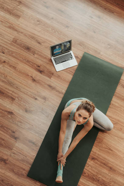 istock Woman doing head to knee yoga pose 1135972937
