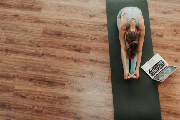 istock Top view woman in seated forward bend yoga pose 1135972941