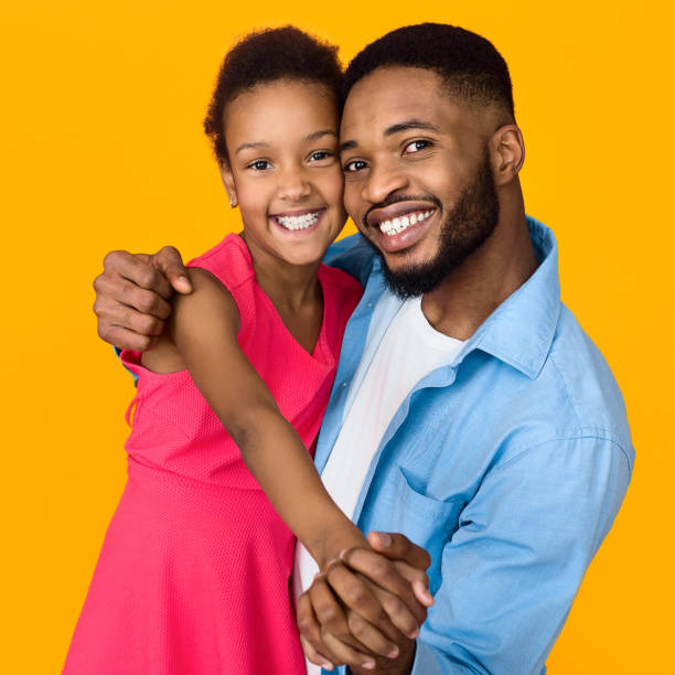 istock African-american father and daughter hugging, having fun 1135972990
