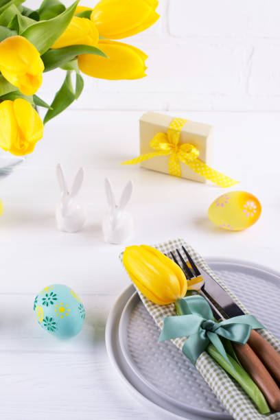 istock Spring Easter background for menu. Easter egg decoration, bunny, linen  napkin on plate and  kitchen cutlery on white wooden table. 1135973183