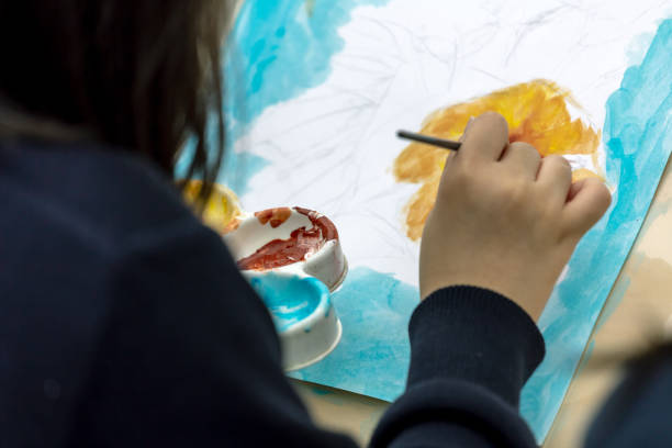 istock painting courses. student drawing at the park 1135974764