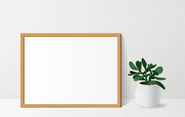 istock Poster mock up with empty wooden frame and crassula plant. 1135976408