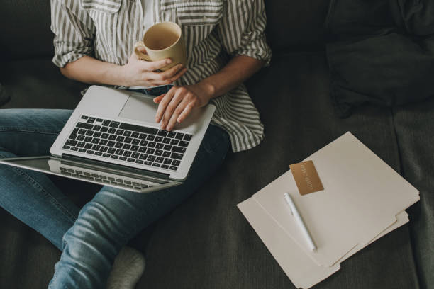 istock Young female working on laptop at home 1135976488