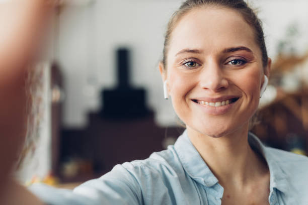 istock Happy smiling lady making selfie by camera 1135976560