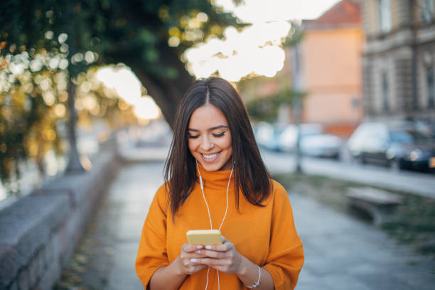 istock Young lady using phone on the street 1135979605