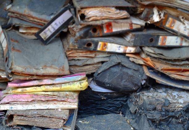 istock Stack of old documents, broken down in black bags, damaged old documents Garbage from office documents Paper stack background 1135980261